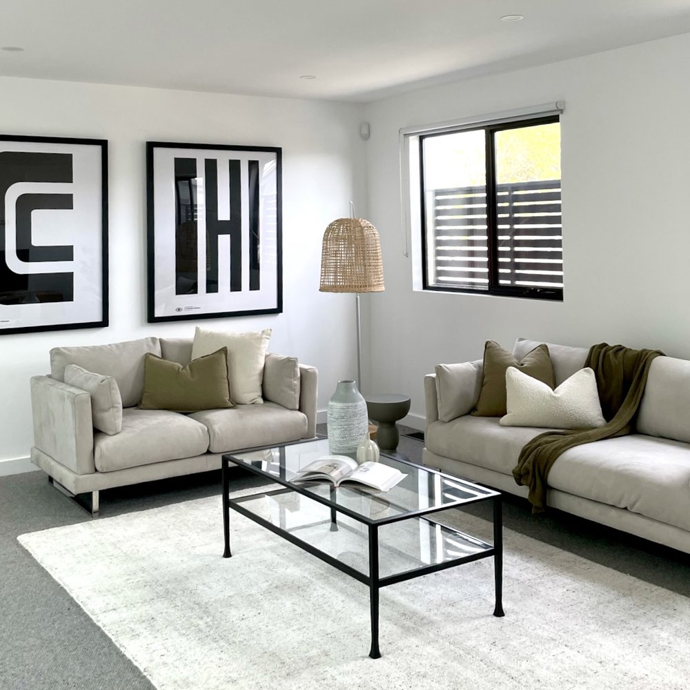Occupied living room updated with select decor and furniture edits before listing