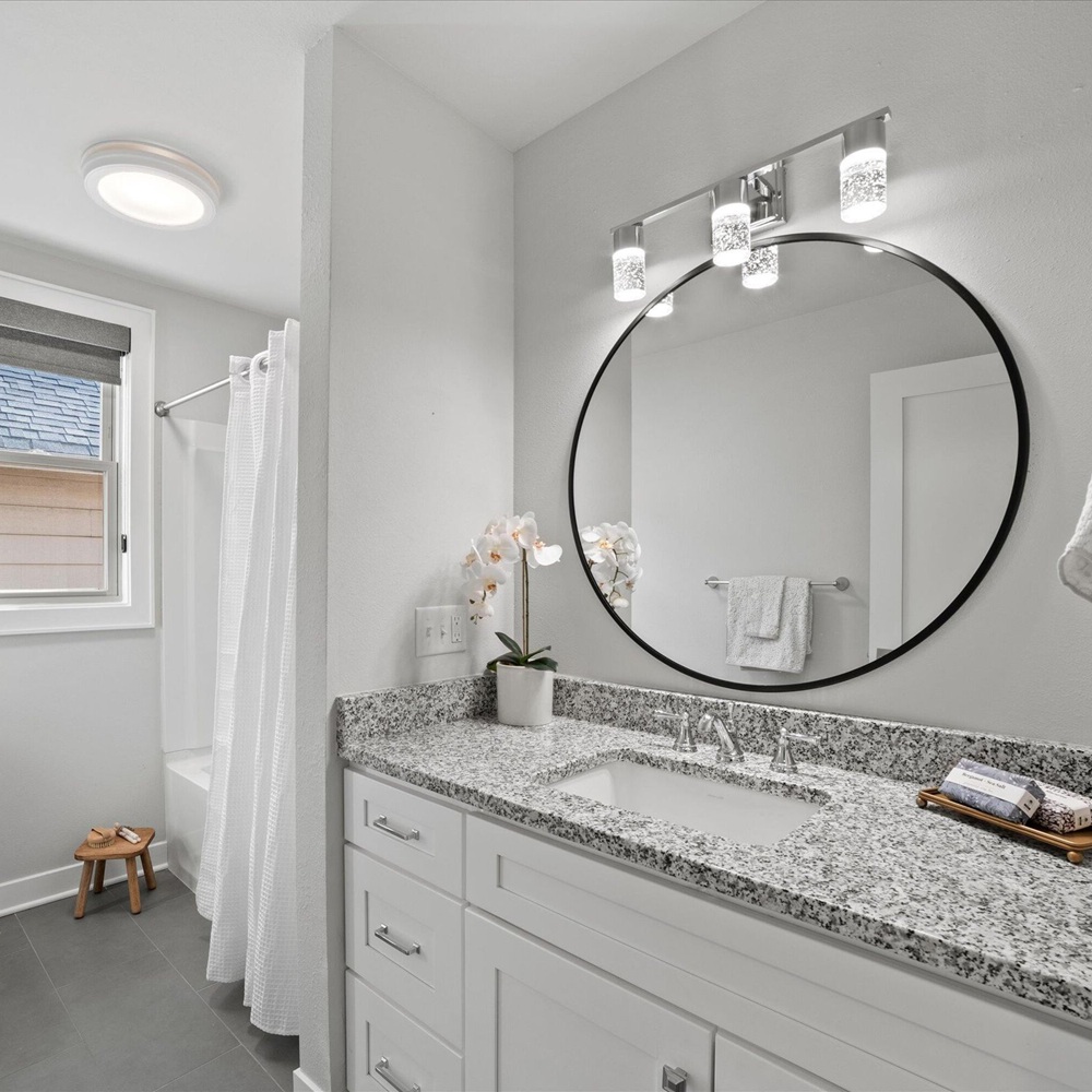 Home stager adjusting existing furniture and decor for polished buyer-ready presentation